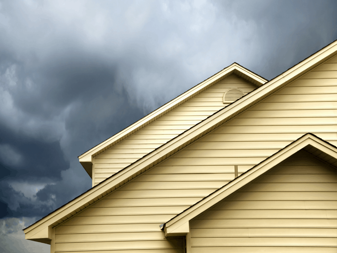 View of home exterior with storm in the background